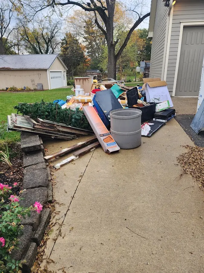 Dumpster being loaded with debris for Roofing Dumpster Rental in Houlton